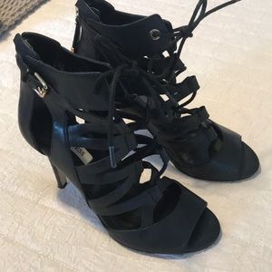 Black soft leather high heel laced sandals.
